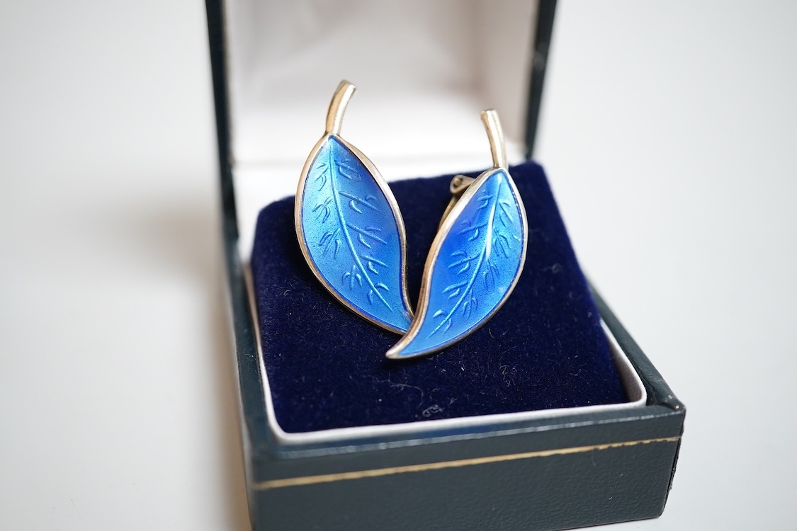 A pair of Norwegian gilt sterling and blue enamel ear clips by David Andersen, 31mm, together with one other Norwegian 925S and blue enamel free form brooch, 47mm and a gilt 925S and red enamel set necklace, 39.5cm.